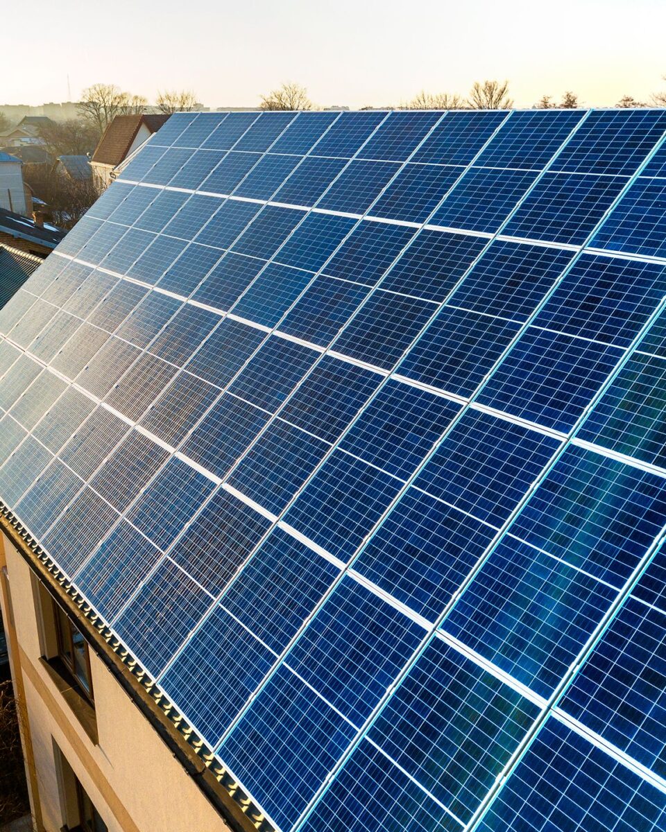 aerial-view-new-modern-two-story-house-cottage-with-blue-shiny-solar-photo-voltaic-panels-system-roof-renewable-ecological-green-energy-production-concept aerial-view-new-modern-two-story-house-cottage-with-blue-shiny-solar-photo-voltaic-panels-system-roof-renewable-ecological-green-energy-production-concept